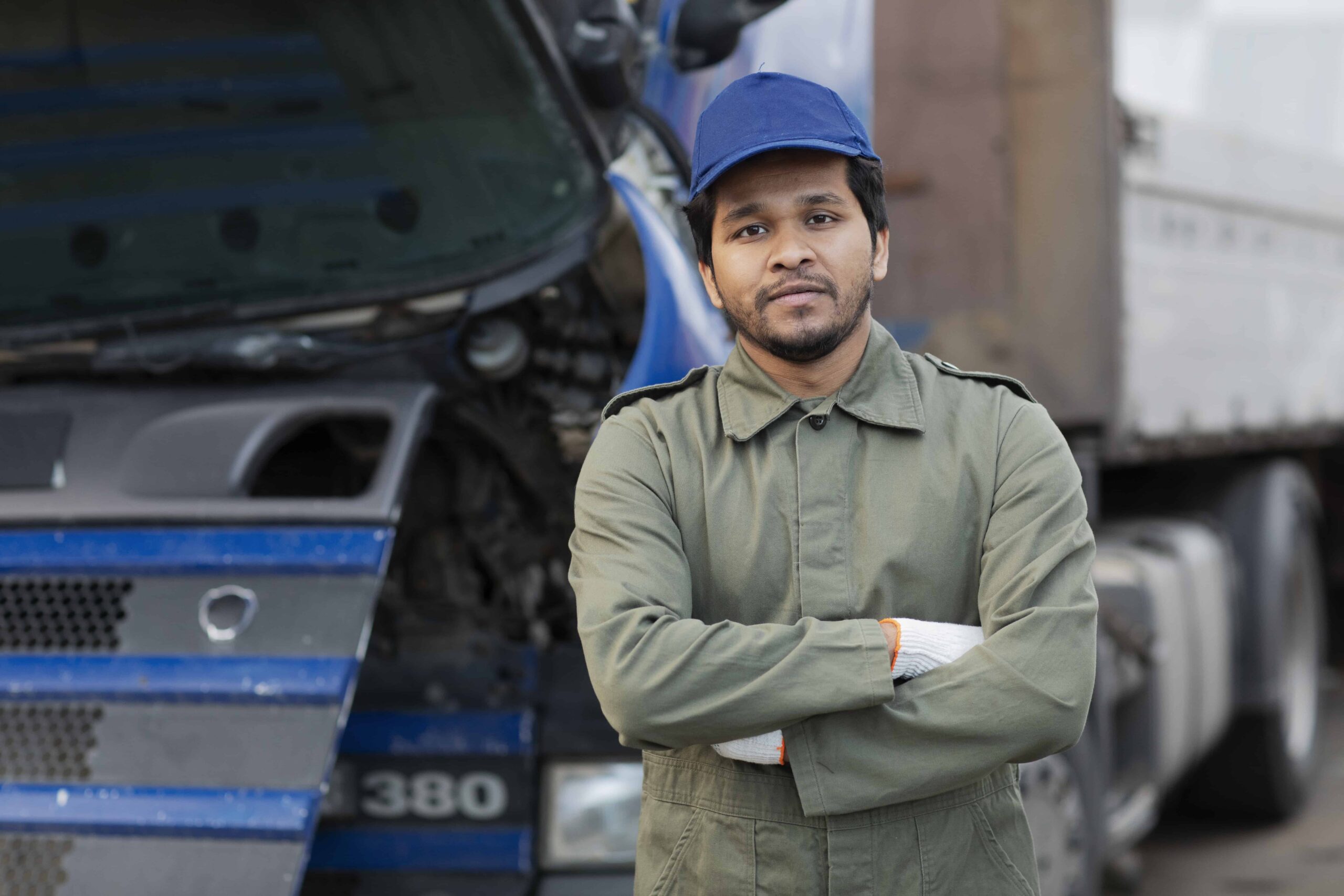 Truck Driver in front of a truck with arms crossed