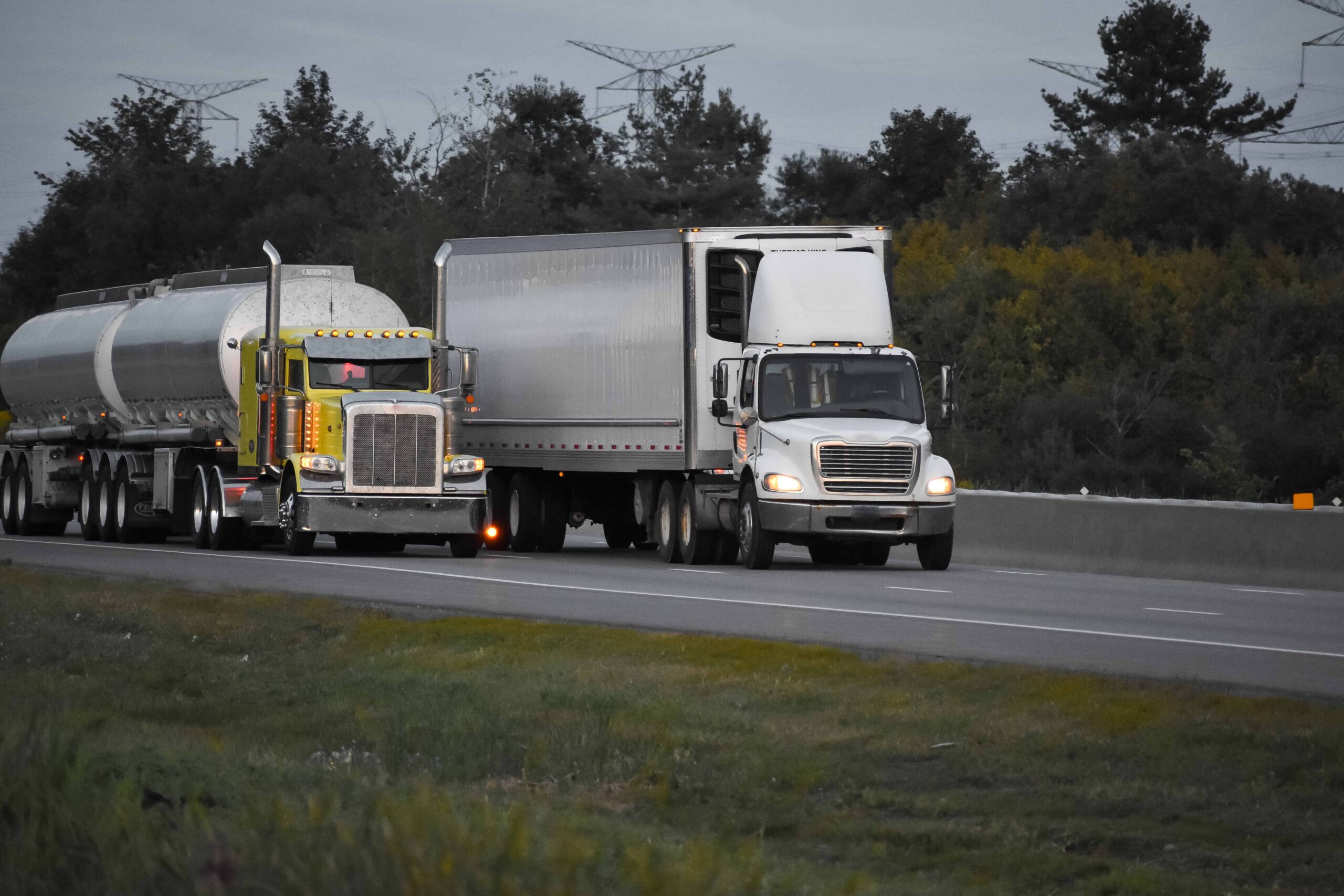 Semi truck and tanker truck driving on highway Semi truck and tanker truck driving on highway