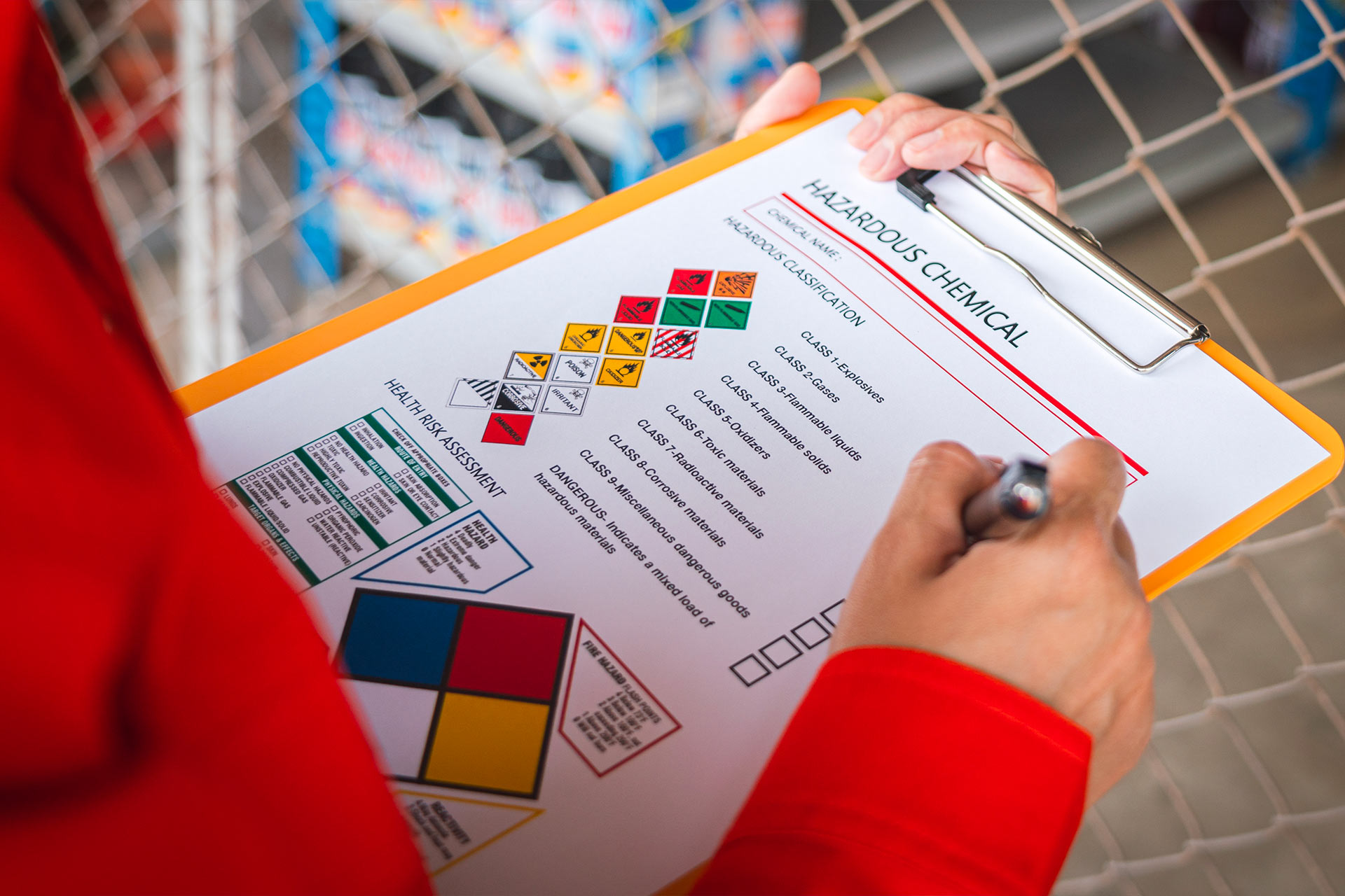 Person filling out a hazmat and dangerous goods safety data sheet Person filling out a hazmat and dangerous goods safety data sheet