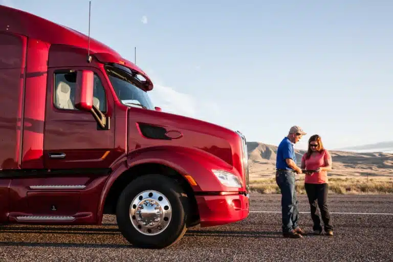 Truck Driver Standing In Front of Truck After Incident Talking to A Woman
